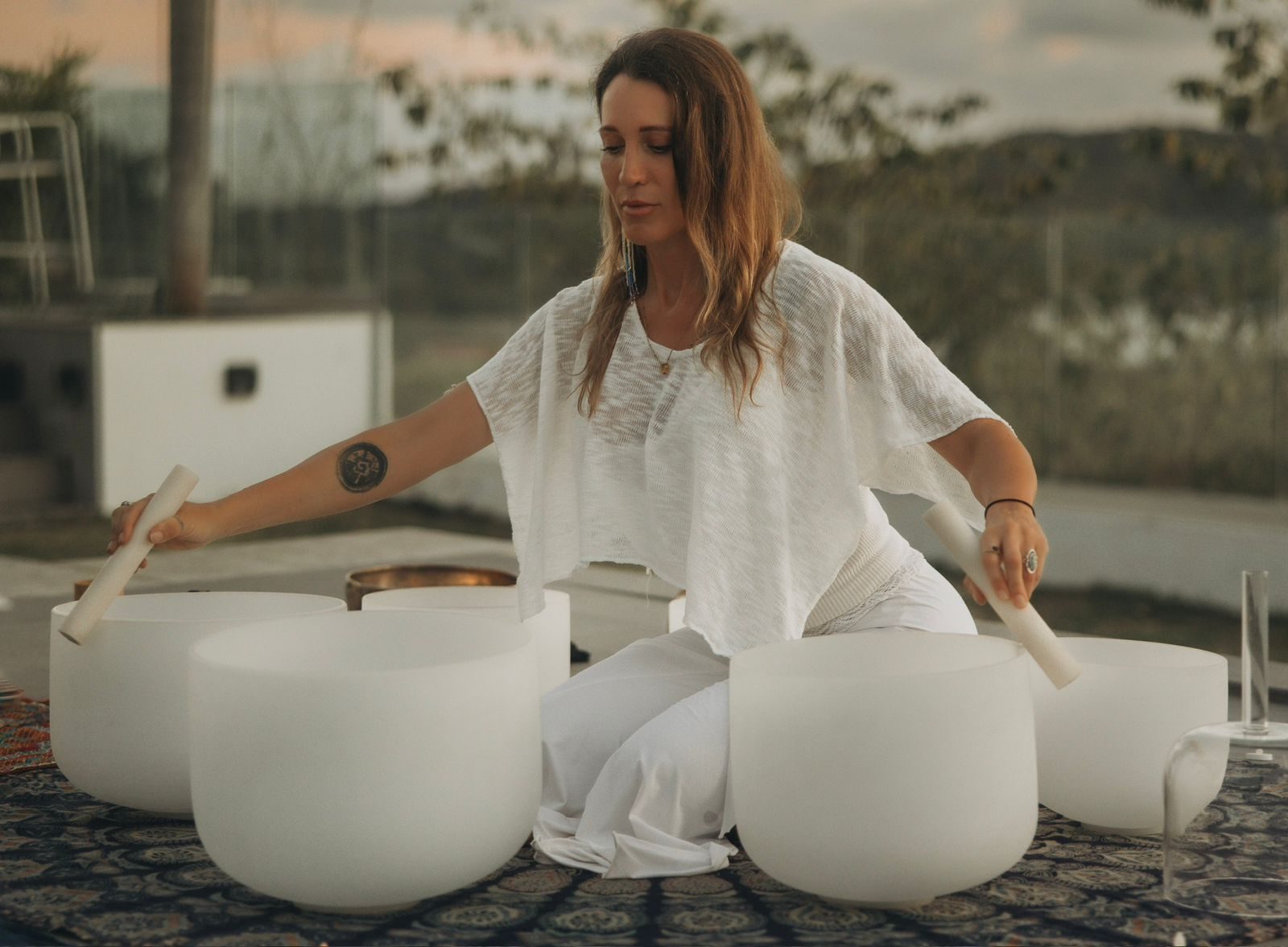 Kate playing crystal bowls at sunset